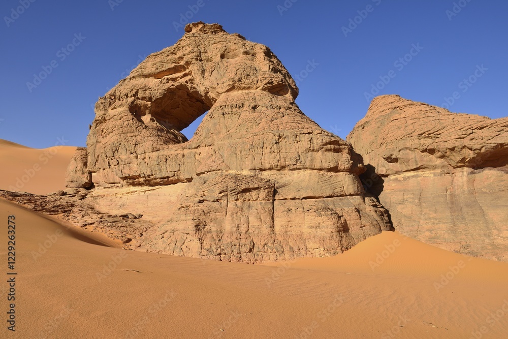 Natural arch with window at Oued el Berdj, Tadrart, Tassili n´Ajjer National Park, Unesco World Heritage Site, Sahara desert, Algeria, Africa Natural arch with window at Oued el Berdj, Tadrart, Tassili n´Ajjer National Park, Unesco World Heritage Site, Sahara desert, Algeria, Africa