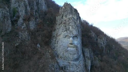 Rock carved statue of the figure of Decebal or Decebalus , on the the kings of historical land of Dacia , first century A.D. ,located in Danube Gorge region, Romania , aerial drone view