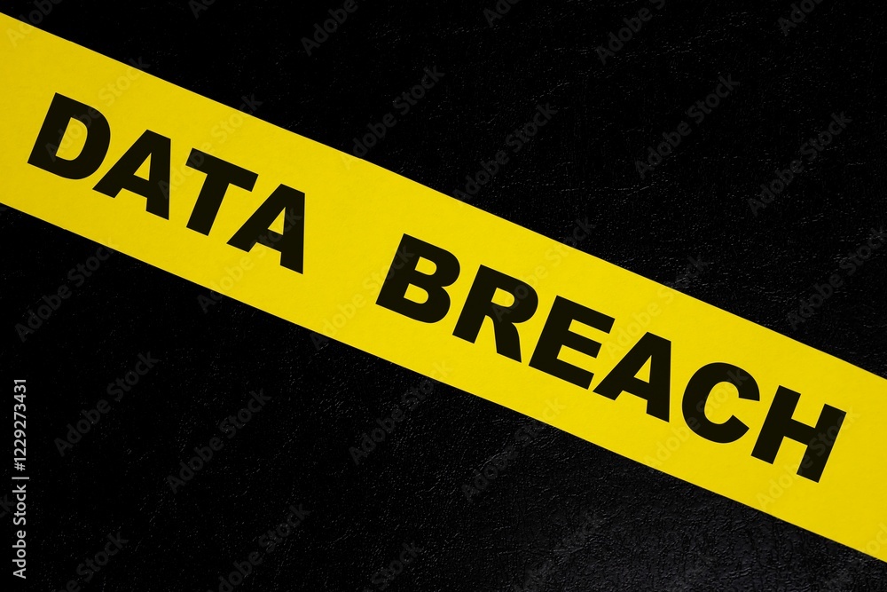 Data breach alert, caution and warning concept. Yellow barricade tape with word in dark black background.
