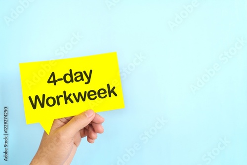 Obraz na płótnie Human hand holding yellow speech bubble with written 4-day work week. w salonie