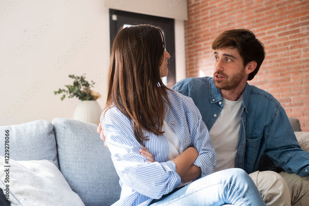 Adult couple sitting on a couch in their living room, facing away from each other, struggling with relationship problems, emotional distance, trust issues, infidelity, heartbreak, and unresolved Adult couple sitting on a couch in their living room, facing away from each other, struggling with relationship problems, emotional distance, trust issues, infidelity, heartbreak, and unresolved