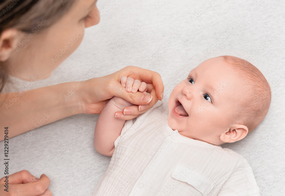 laughing baby communicates with his mother and holds her hand laughing baby communicates with his mother and holds her hand