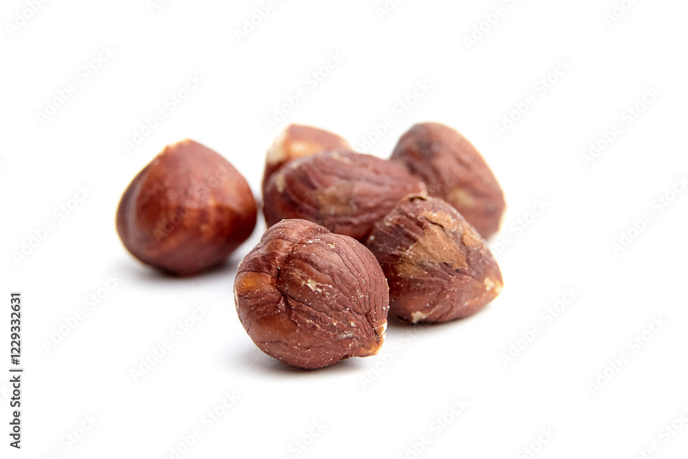 A group of raw hazelnuts with a rich brown texture displayed on a clean white background, highlighting their natural and fresh appearance