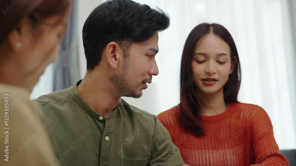 asian financial advisor presenting charts and data on a tablet during couple client meeting.financial planning and decision-making asian financial advisor presenting charts and data on a tablet during couple client meeting.financial planning and decision-making