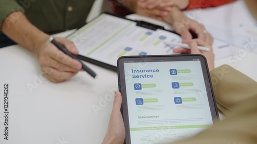 Asian financial consultant explaining investment insurance to  couple using a laptop at home.financial planning for future goals.
