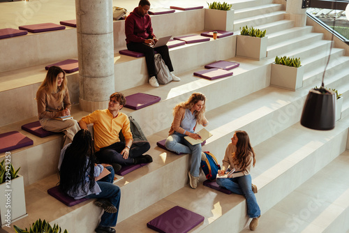 Obraz na płótnie University students studying and chatting on modern bleachers