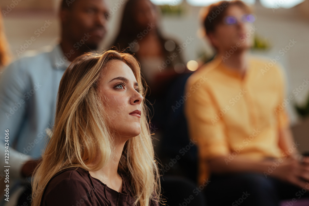 Fototapeta premium Businesswoman listening attentively during a conference meeting