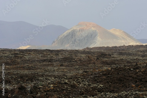 Fényképezés Field with clumps of lava in front of Caldera de los Arrables in the uninhabited