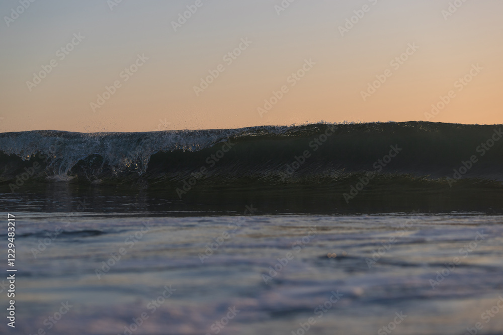 Fototapeta premium Wave breaking on the beach shore.