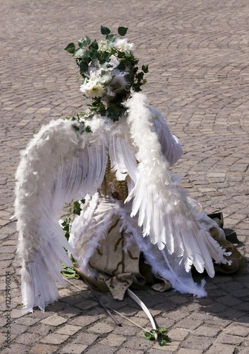 Street performer wearing an angel costume photo