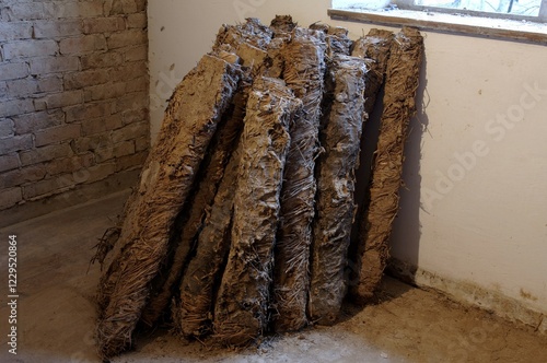 Old loam bundles used for attic insulation, at a farm estate built in 1922