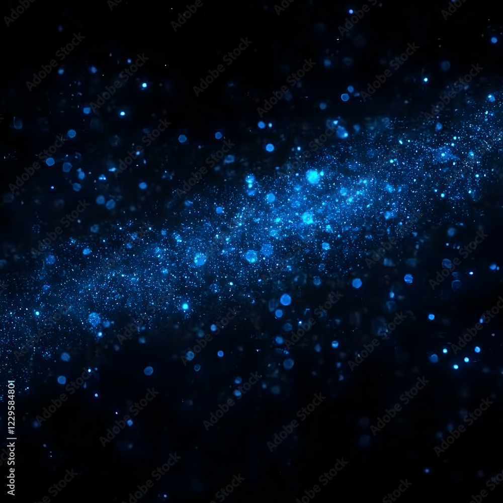 Fototapeta premium Abstract blue glitter sparkles on a dark background, creating a magical and festive atmosphere.