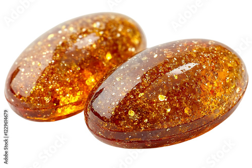 Two Shiny Oval Caramel Candies with Golden Specks on Black Backg
