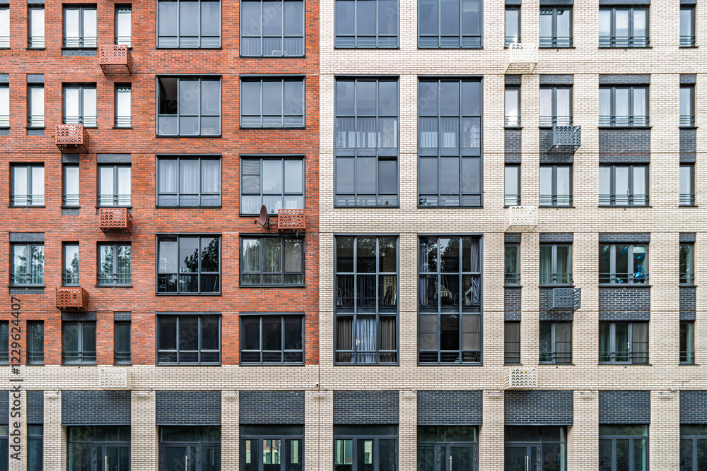 Contemporary multi-story buildings with beige, red brick and glass facades, showcasing balconies and windows. Urban architecture concept, front view Contemporary multi-story buildings with beige, red brick and glass facades, showcasing balconies and windows. Urban architecture concept, front view
