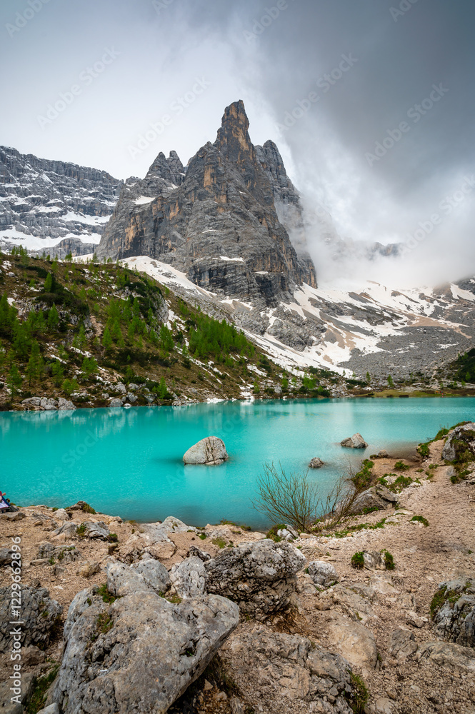 Panoramic view of Lago Sorapis in the Dolomites (Dolomiti, Dolomiten), Italy. The turquoise lake is surrounded by towering cliffs and mountains, a popular spot for hikers and nature lovers