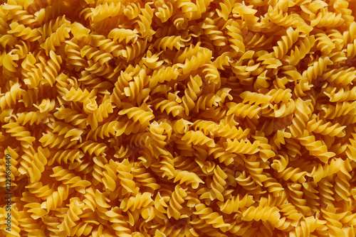close up raw yellow italian fusilli pasta background 