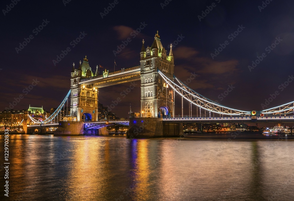 Fototapeta premium Illuminated Tower Bridge at night, water reflection, Southwark, London, England, United Kingdom, Europe