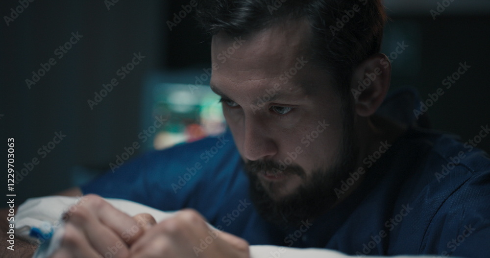 Man clenches fists in aggression, sitting on bed in hospital bed. Man clenches fists in aggression, sitting on bed in hospital bed.