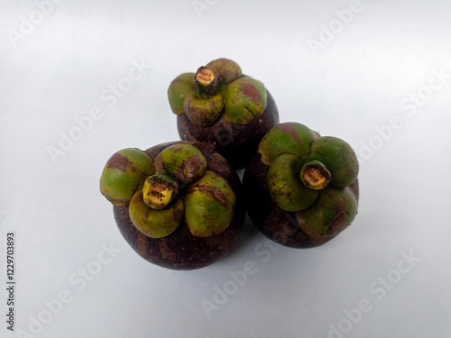 The fruit of Mangosteen or Garcinia mangostana or purple is sweet and sour, juicy, somewhat fibrous, with vesicles filled with liquid (like the flesh of citrus fruits). photo