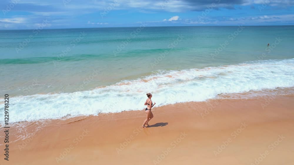 Young woman runs along the beach enjoying her vacation Young woman runs along the beach enjoying her vacation