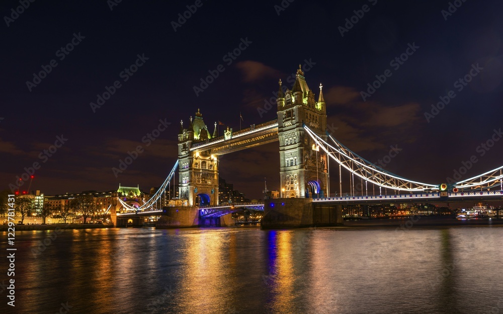 Fototapeta premium Illuminated Tower Bridge at night, water reflection, Southwark, London, England, United Kingdom, Europe