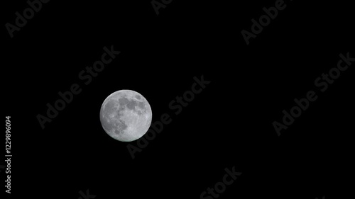 The moon floats across the sky. Close-up.