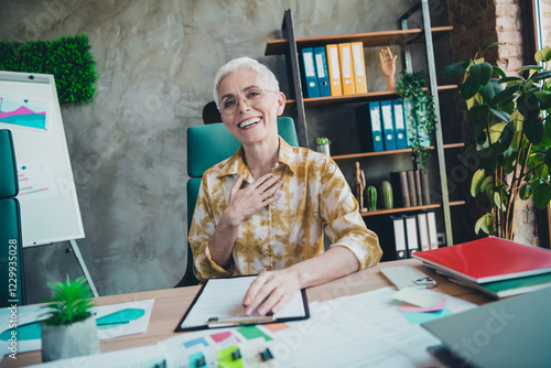 Photo of attractive senior woman have fun laughing wear yellow print shirt formalwear comfy modern office room interior indoors workspace photo