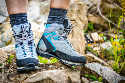 Professional hiking boots on the rock photo