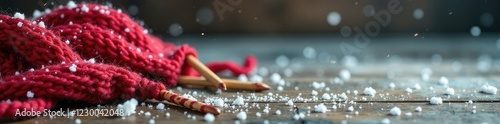 Knitting needles on a wooden table amidst snowflakes, fiberart, handmade photo