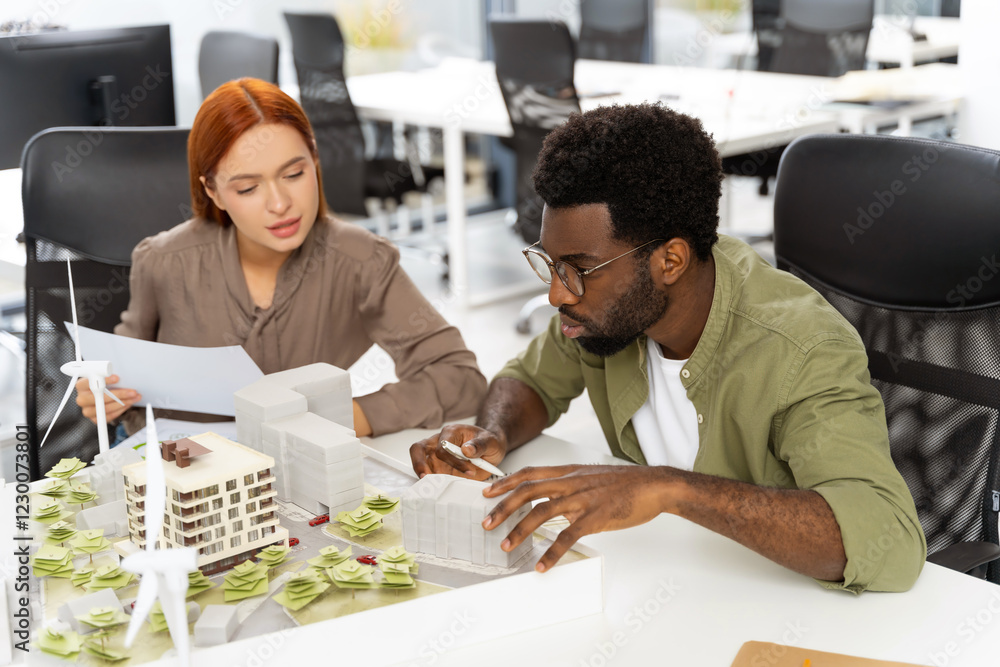Two colleagues working in the office on a new sustainable project