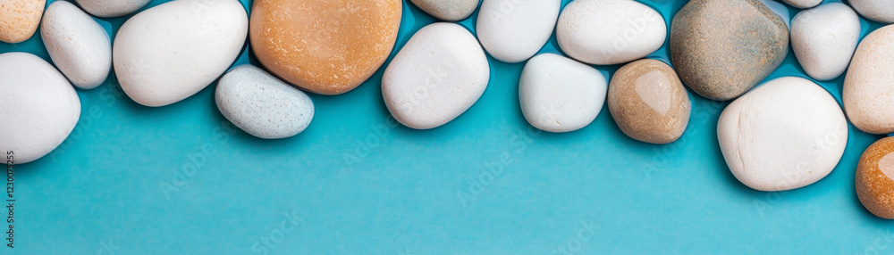 Smooth pebbles arranged beautifully on a teal background. Smooth pebbles arranged beautifully on a teal background.