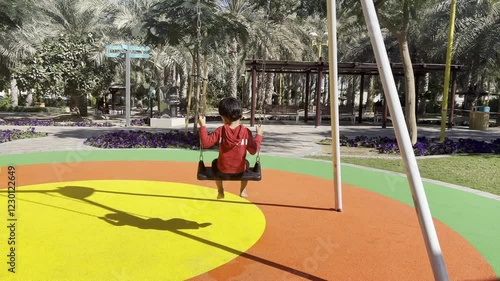 Kids playing in park. Kid with red colored jacket