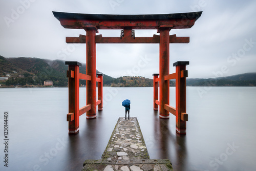 Obraz na płótnie Person standing under red torii gate at Lake Ashi, Hakone, Kanagawa Prefecture, Japan w salonie