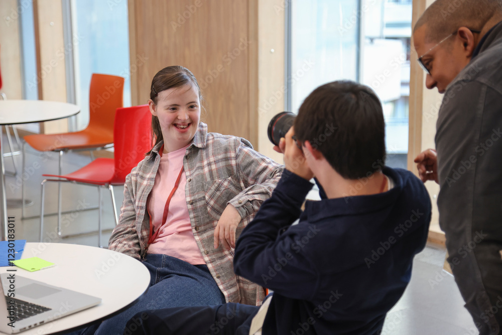 Man and teenage girl�with Down Syndrome at photography class Man and teenage girl�with Down Syndrome at photography class