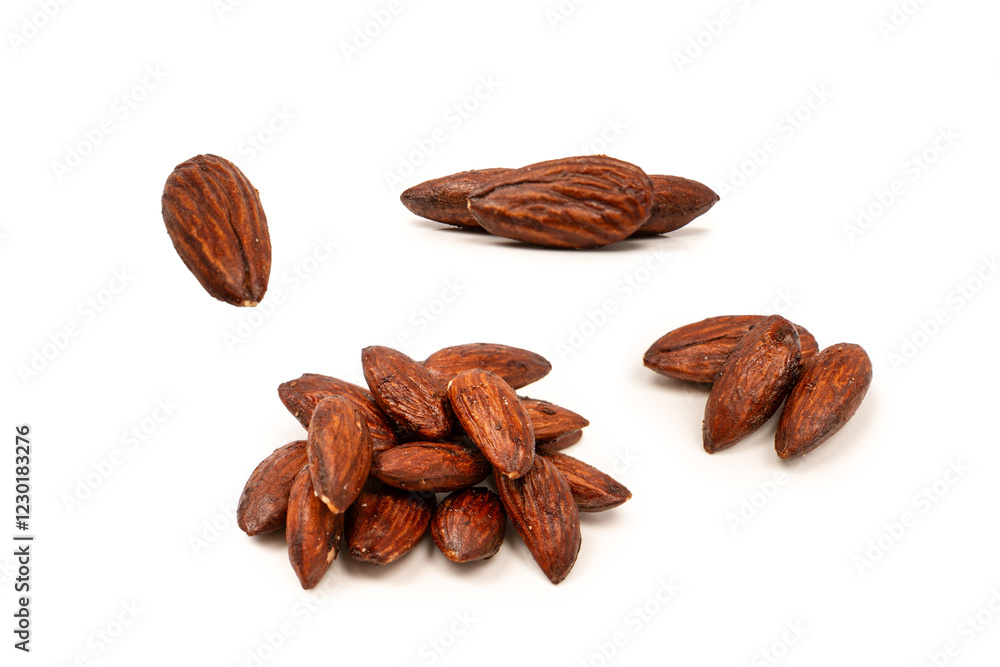 A group of caramelized almonds isolated on a white background. A group of caramelized almonds isolated on a white background.