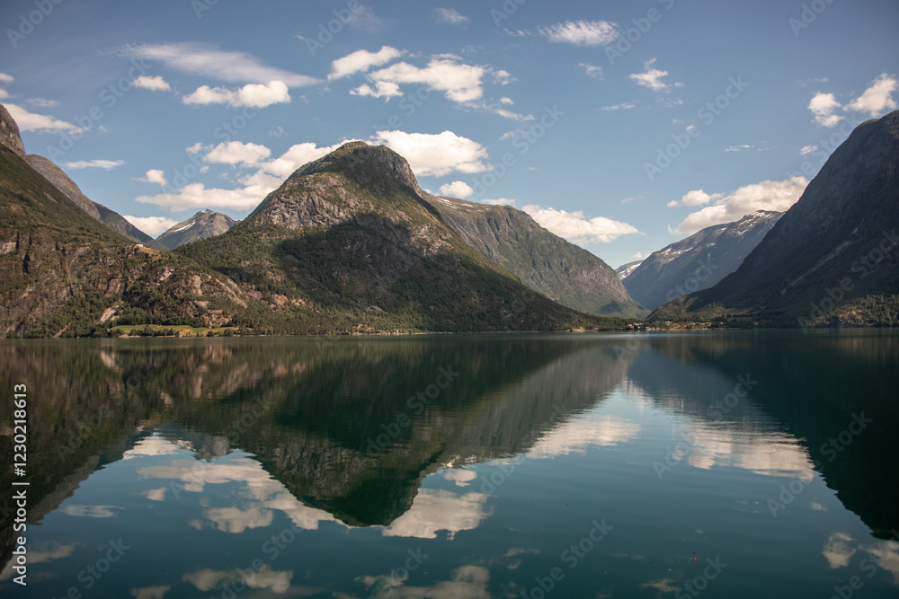 Fototapeta premium See mit perfekter Spiegelung von Bergen und Wolken