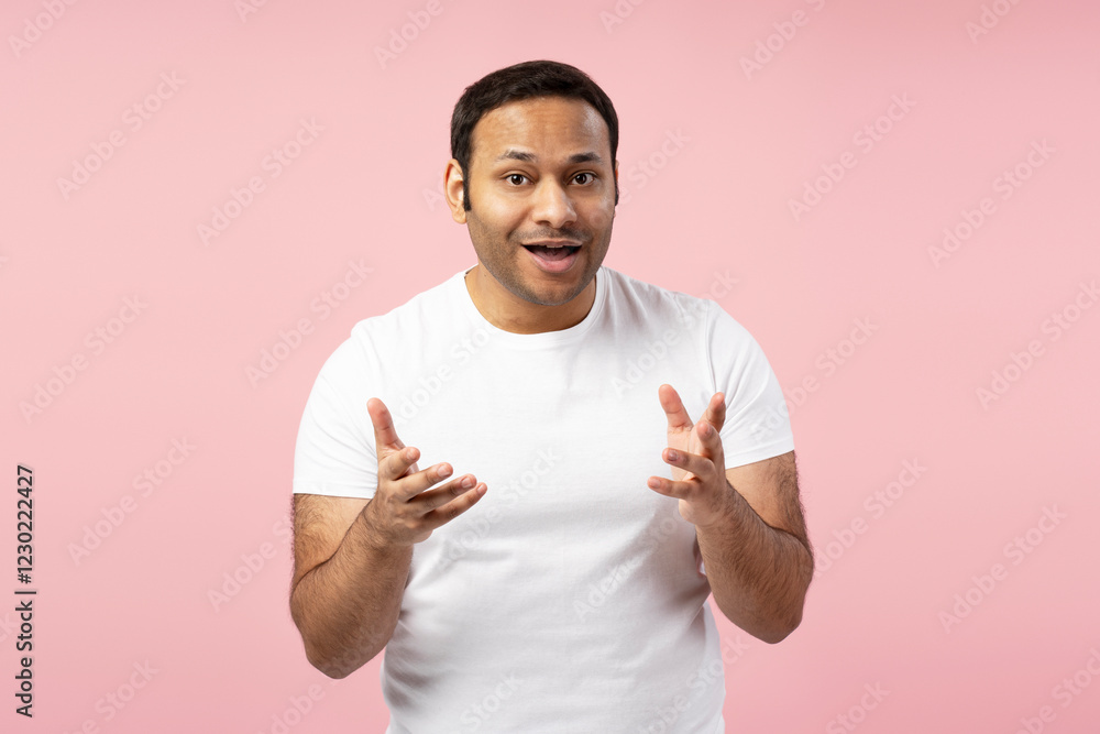 Excited man gesturing with hands on pink background Excited man gesturing with hands on pink background