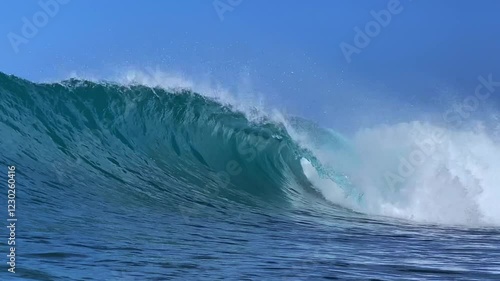 Perfect blue ocean wave breaks on the shore in Indonesia.Slow motion video.View from the water
