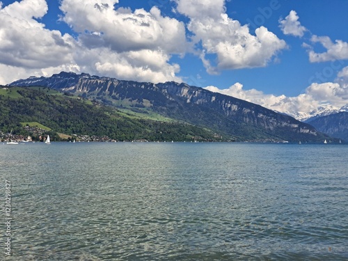 A lake in the Swiss Alps. The Blue Lake in Switzerland. Snow-capped mountains near the lake. Spring.