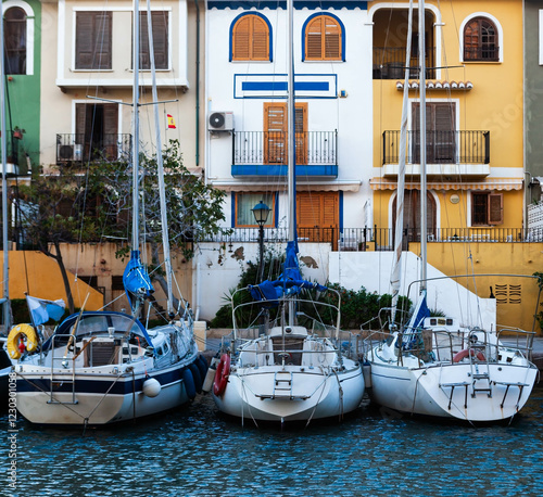 Sailboats parked in front of houses in Port de Sagunt near Valencia, Spain. photo