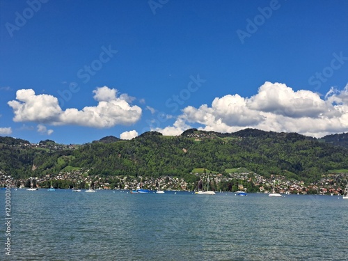 A lake in the Swiss Alps. The Blue Lake in Switzerland. Snow-capped mountains near the lake. Spring.
