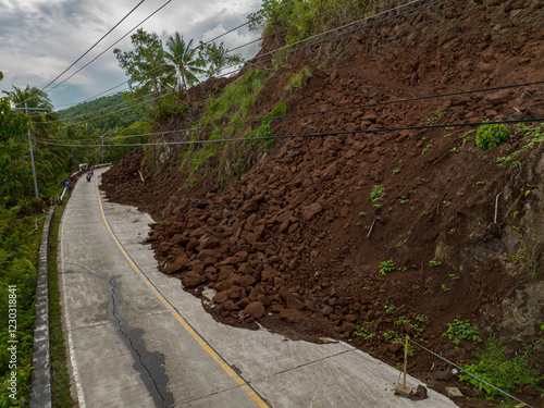 Heavy rainfall cause the landslides that block the half of the road. Camiguin, Philippines. photo