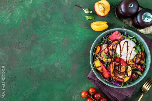 Delicious summer salad with burrata cheese and grilled peaches, arugula and microgreens.