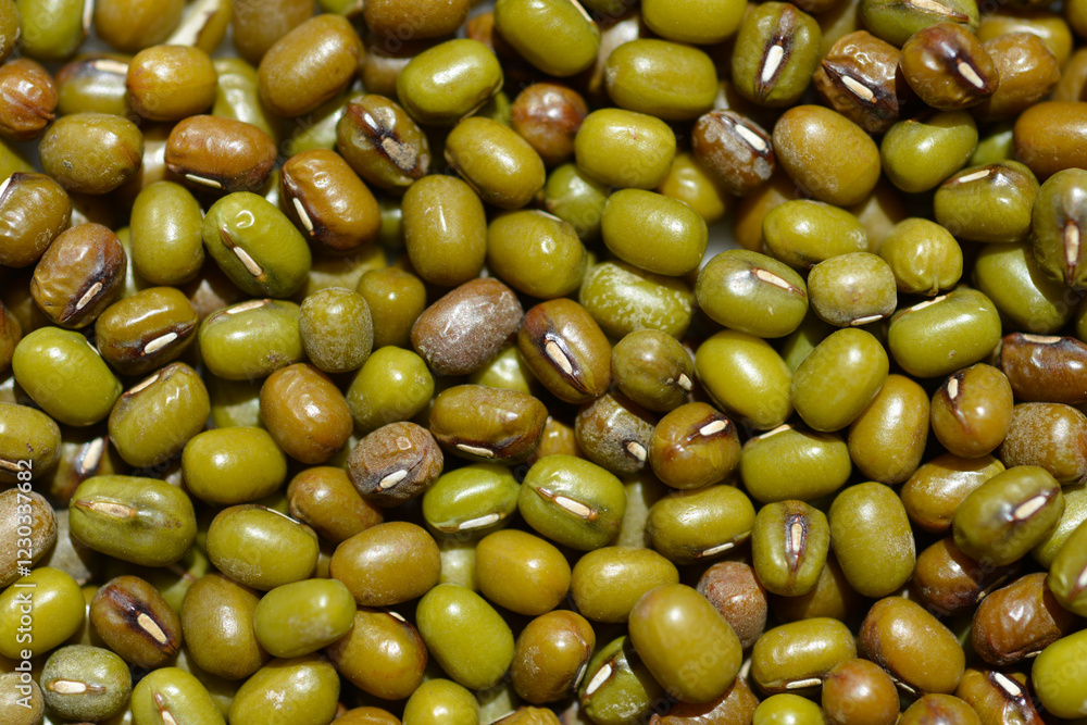 Detail of a surface covered with dry uncooked mung beans Detail of a surface covered with dry uncooked mung beans