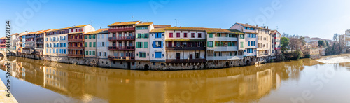 Fotografie Facades of houses in the town of Castres on the Agout River in Occitanie, France