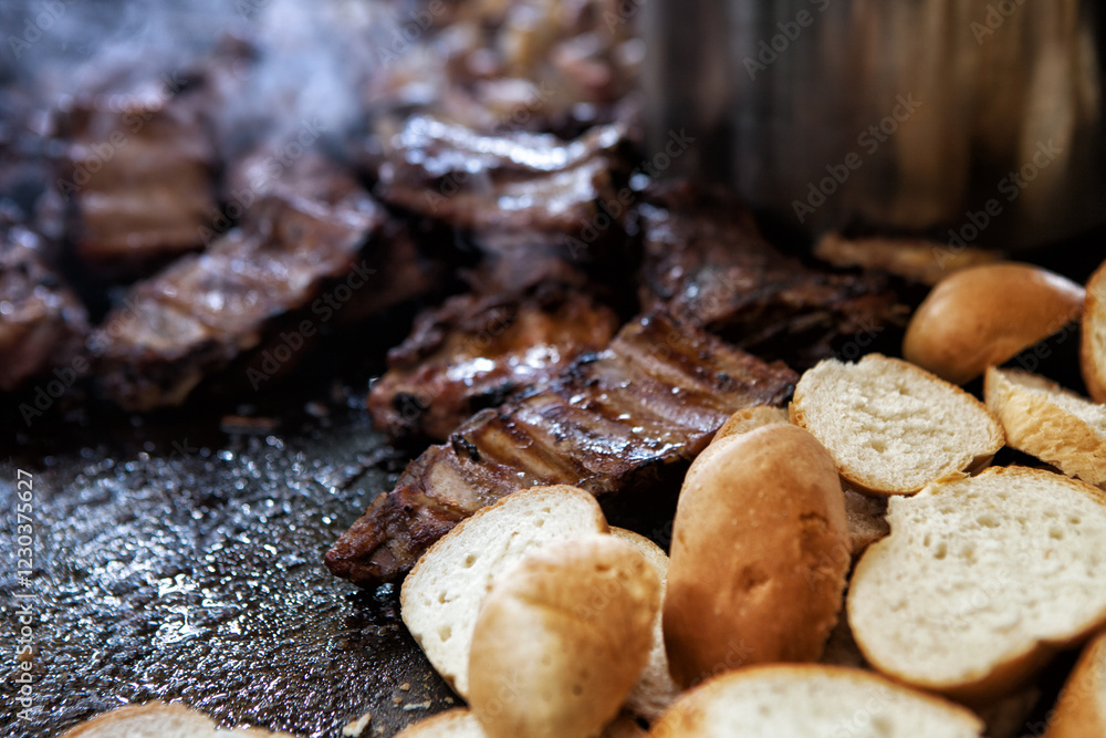 Close-up of many pieces of bread with meat on the grill in the background. Lots of bread on the grill with smoke in a pronounced texture. Street food festival. Close-up of many pieces of bread with meat on the grill in the background. Lots of bread on the grill with smoke in a pronounced texture. Street food festival.