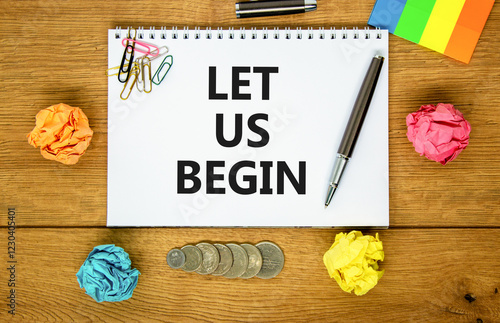 Let us begin symbol. Concept words Let us begin on beautiful white note. Beautiful wooden background. Black pen. Colored paper. Business motivational let us begin concept. Copy space. photo