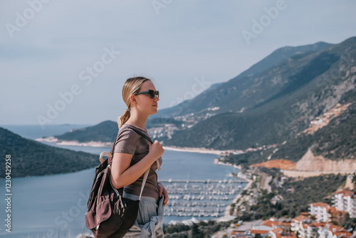 ourney, young woman embarks solo journey, middle breathtaking mountain panorama. Embracing self-care digital nomad lifestyle, freedom, adventure and personal growth photo