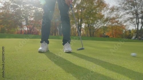 Low Angle Shot of a Golf Player Putting the Golf Ball Into the Hole 4K 