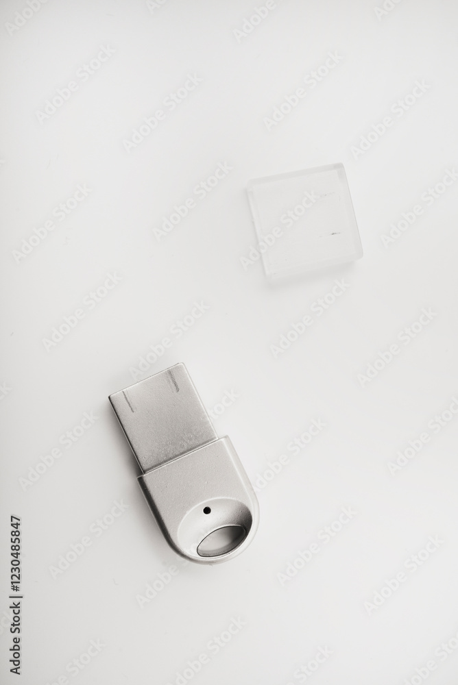 Fototapeta premium The metal case of the USB adapter. Wi-Fi module on a white background. The Bluetooth adapter's whistle.